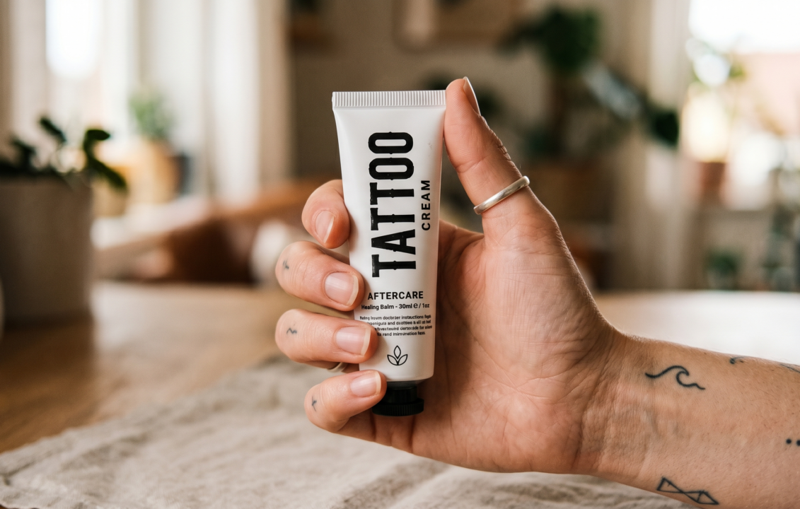 Hand holding a tattoo cream